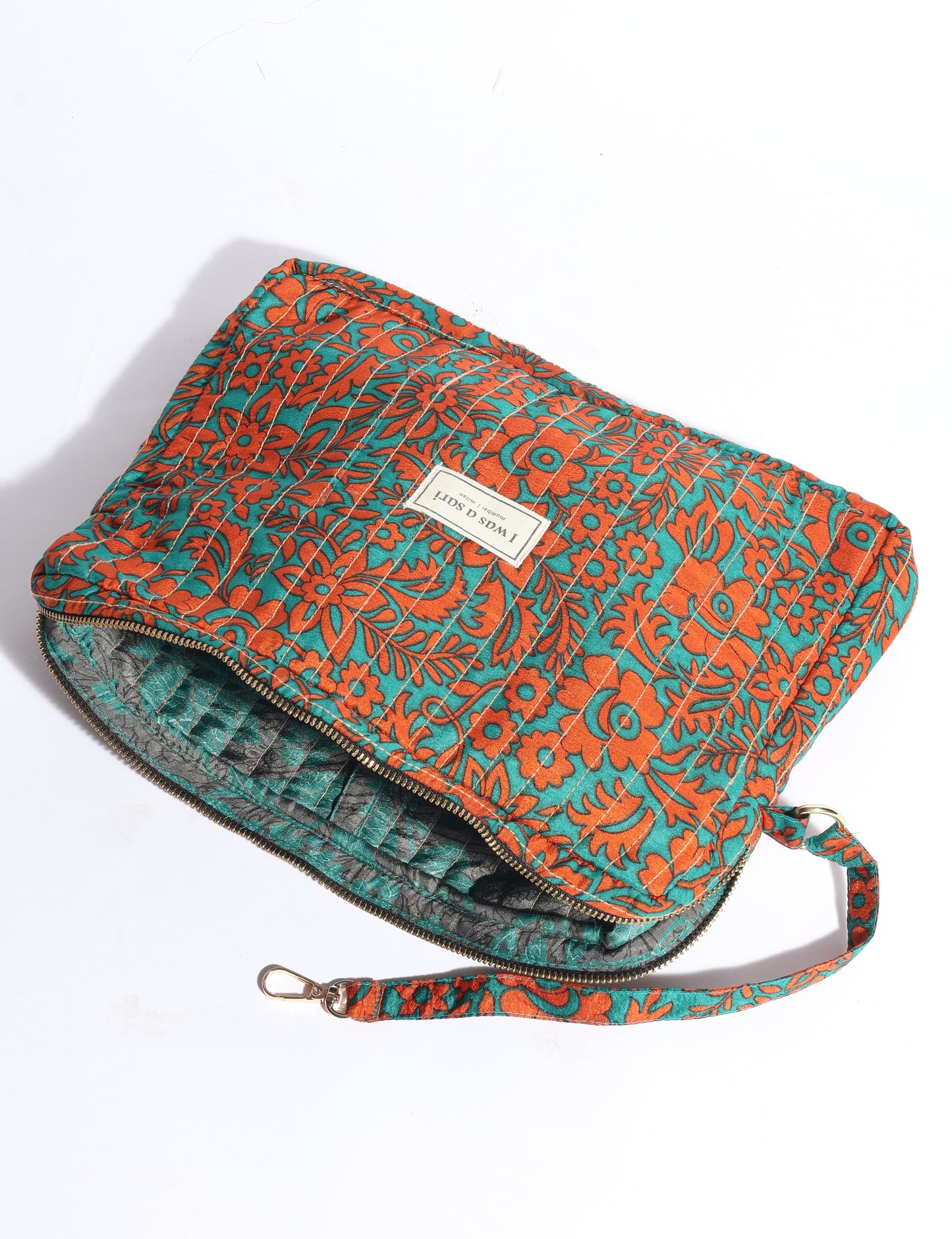 Quilted sling bag with adjustable strap, front zip pocket, and curved silhouette for everyday use