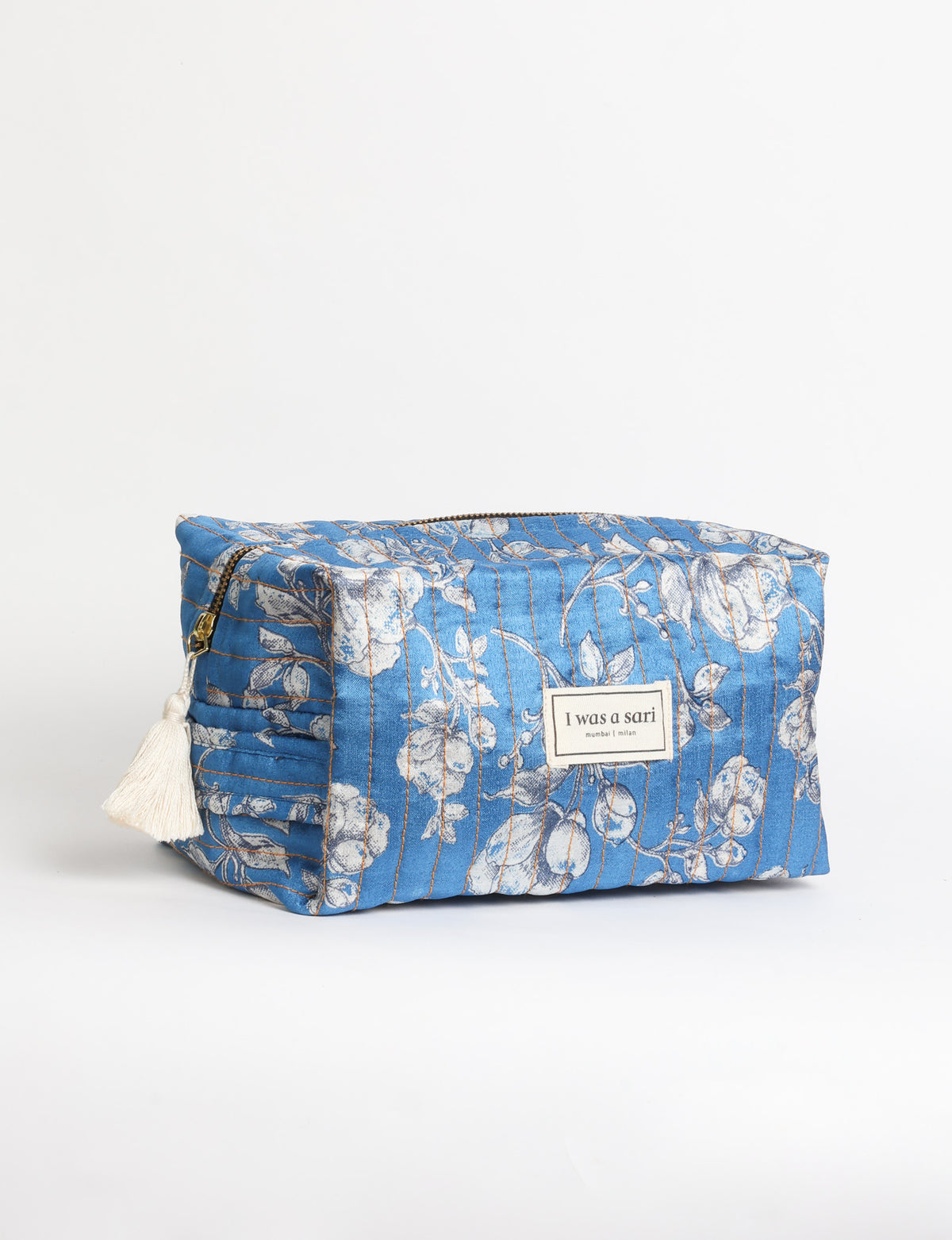 Quilted utility pouch with a structured shape, top zip closure, and flat base for organising everyday essentials.