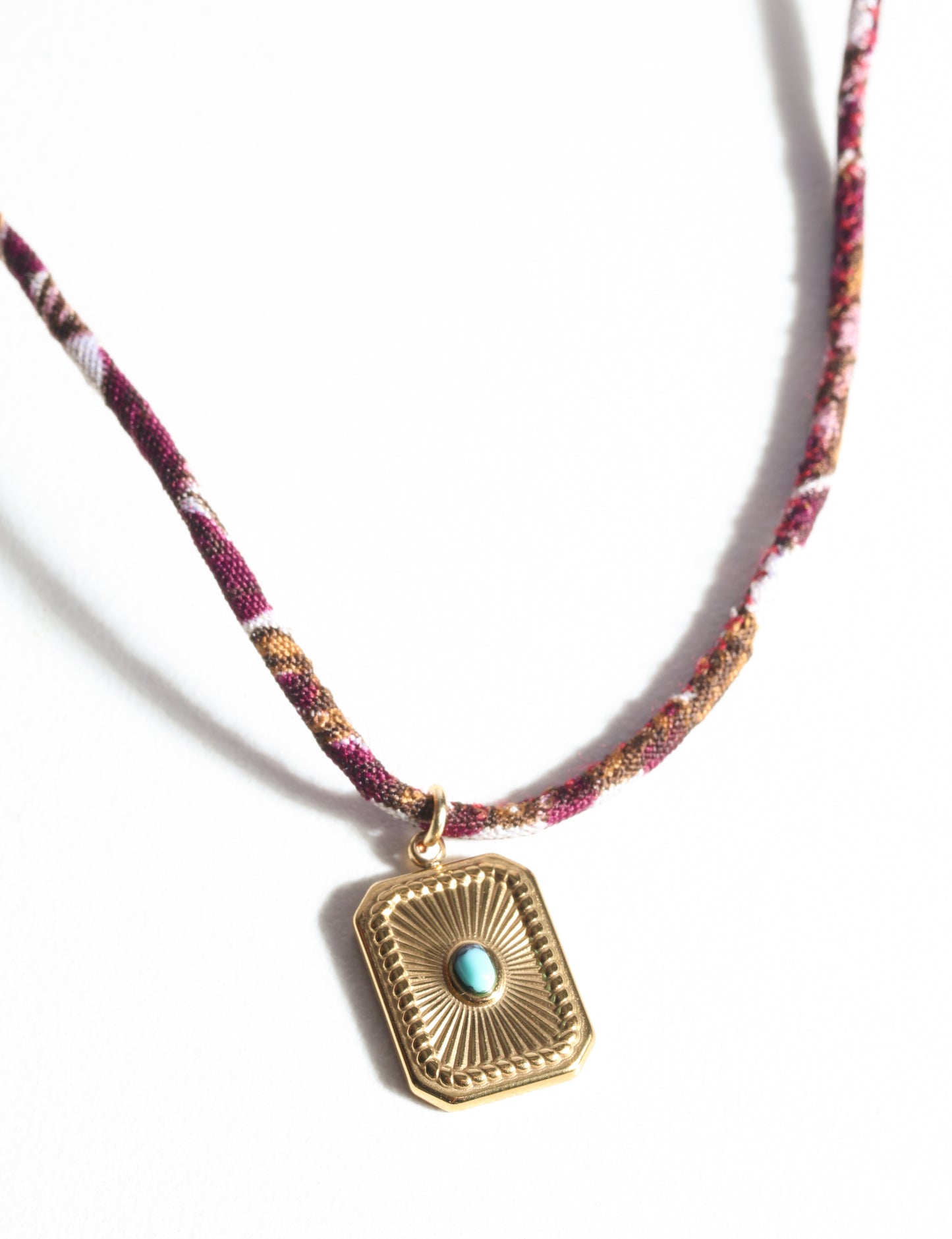 Adjustable cord necklace with gold-plated metal pendant inspired by upcycled women’s clothing, sustainable women’s clothing, eco friendly fashion, recycled sustainable fashion, carbon neutral fashion, and environment friendly clothing principles.
