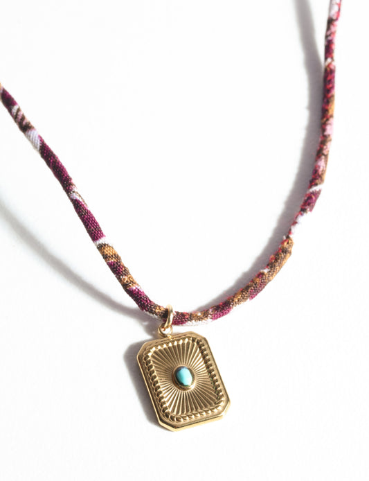 Adjustable cord necklace with gold-plated metal pendant inspired by upcycled women’s clothing, sustainable women’s clothing, eco friendly fashion, recycled sustainable fashion, carbon neutral fashion, and environment friendly clothing principles.