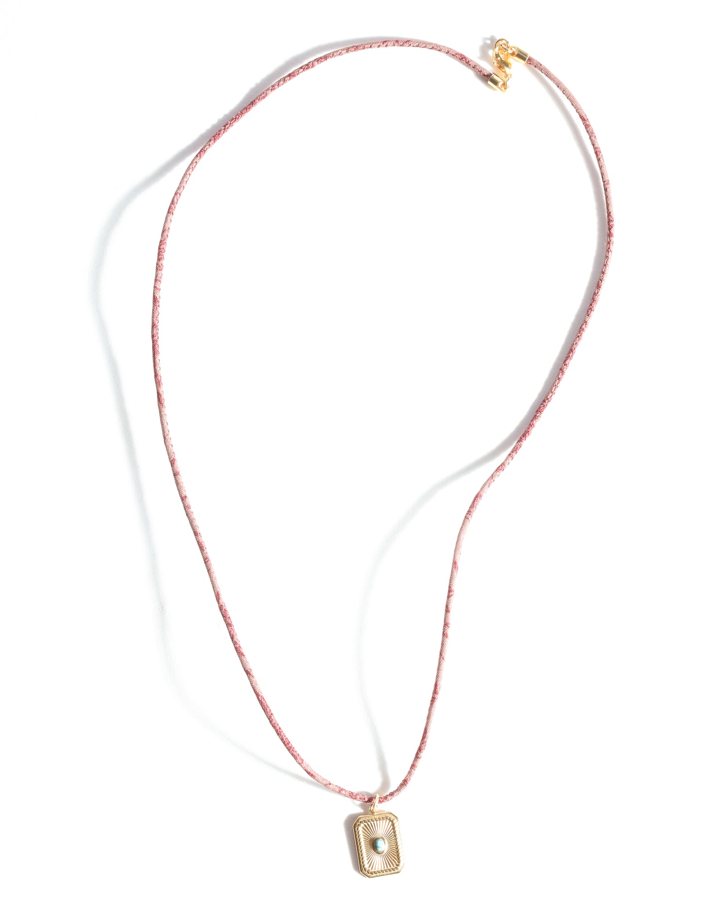 Adjustable cord necklace with gold-plated metal pendant inspired by upcycled women’s clothing, sustainable women’s clothing, eco friendly fashion, recycled sustainable fashion, carbon neutral fashion, and environment friendly clothing principles.