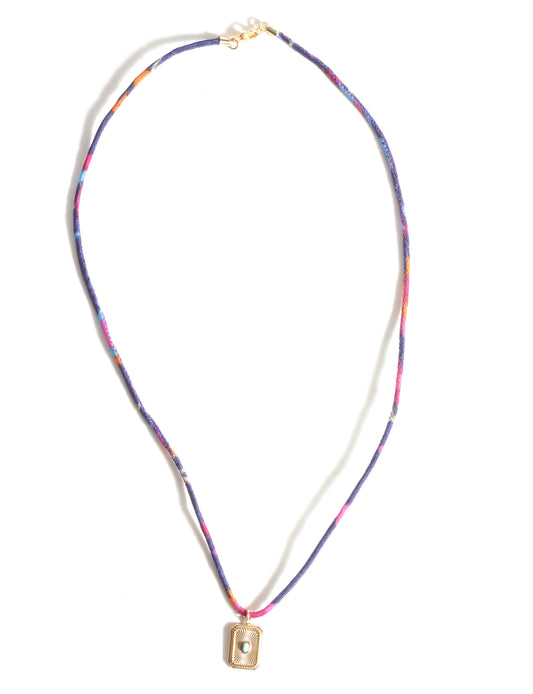 Adjustable cord necklace with gold-plated metal pendant inspired by upcycled women’s clothing, sustainable women’s clothing, eco friendly fashion, recycled sustainable fashion, carbon neutral fashion, and environment friendly clothing principles.