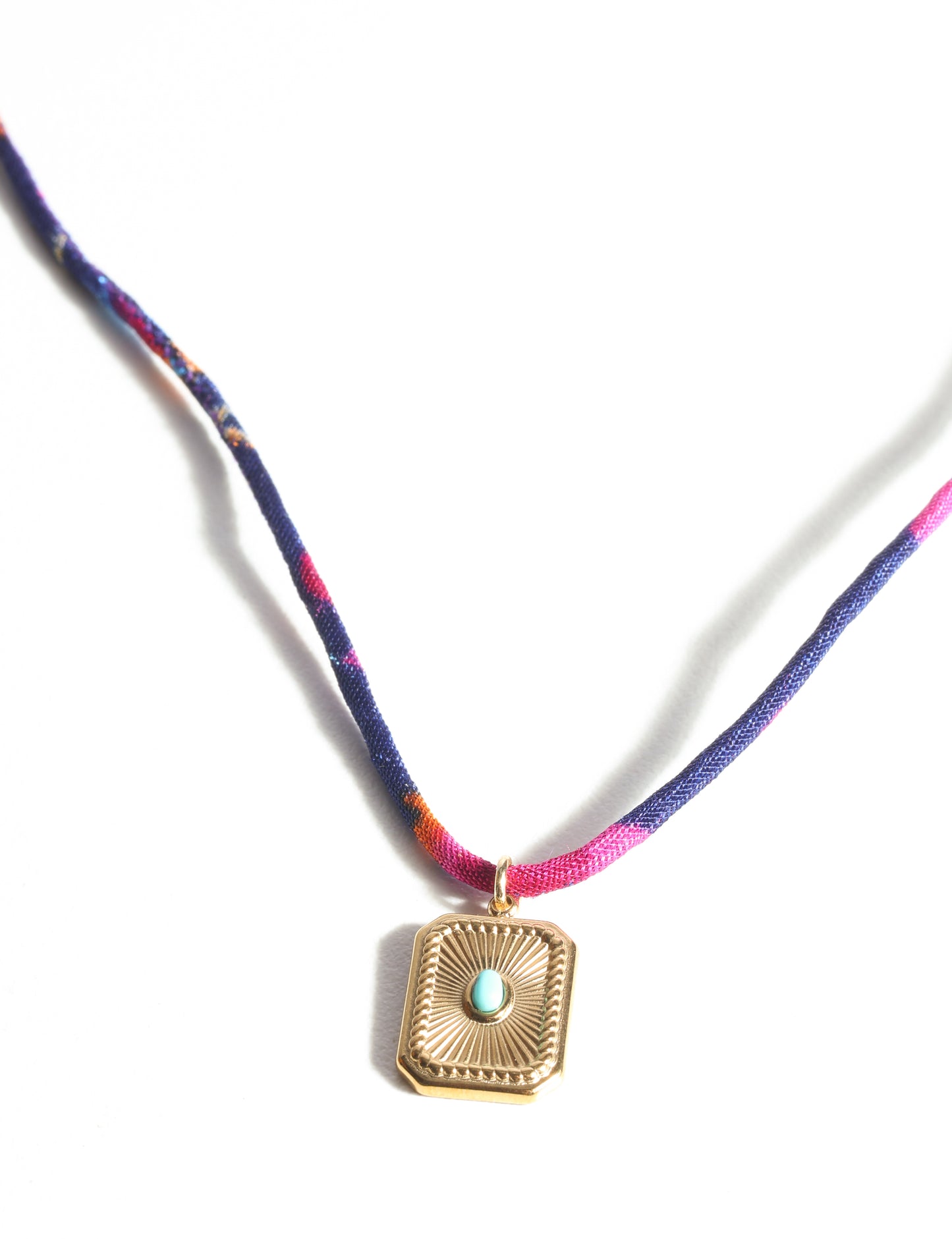 Adjustable cord necklace with gold-plated metal pendant inspired by upcycled women’s clothing, sustainable women’s clothing, eco friendly fashion, recycled sustainable fashion, carbon neutral fashion, and environment friendly clothing principles.