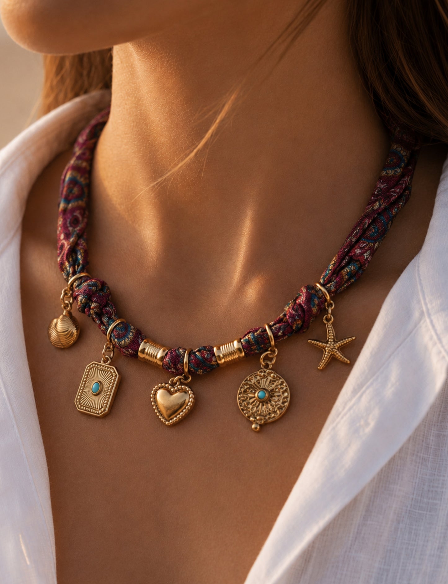 Bandana necklace with gold-plated charms, adjustable tie-back design, stainless steel hardware, handmade statement necklace, sustainable fashion accessory.