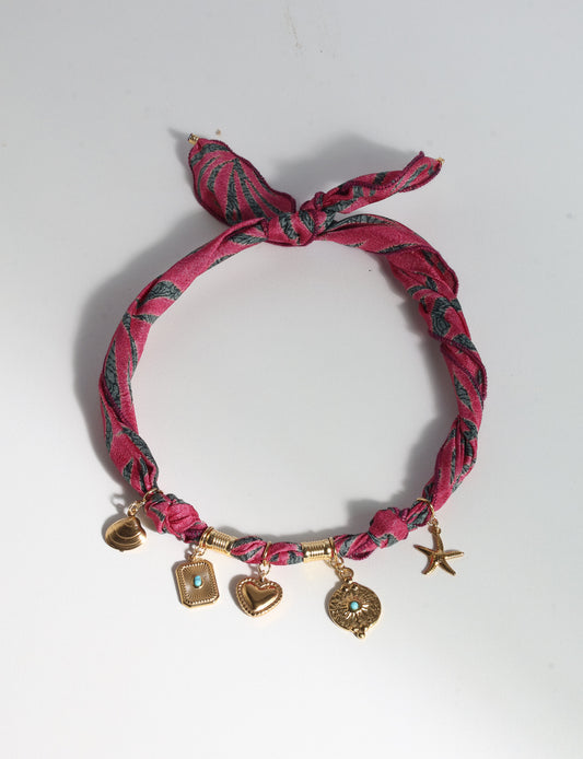 Bandana necklace with gold-plated charms, adjustable tie-back design, stainless steel hardware, handmade statement necklace, sustainable fashion accessory.