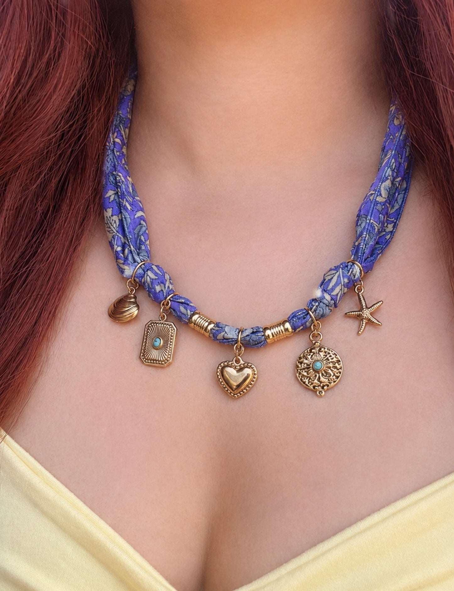 Bandana necklace with gold-plated charms, adjustable tie-back design, stainless steel hardware, handmade statement necklace, sustainable fashion accessory.