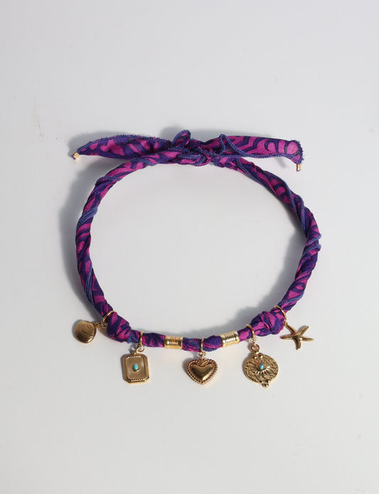 Bandana necklace with gold-plated charms, adjustable tie-back design, stainless steel hardware, handmade statement necklace, sustainable fashion accessory.