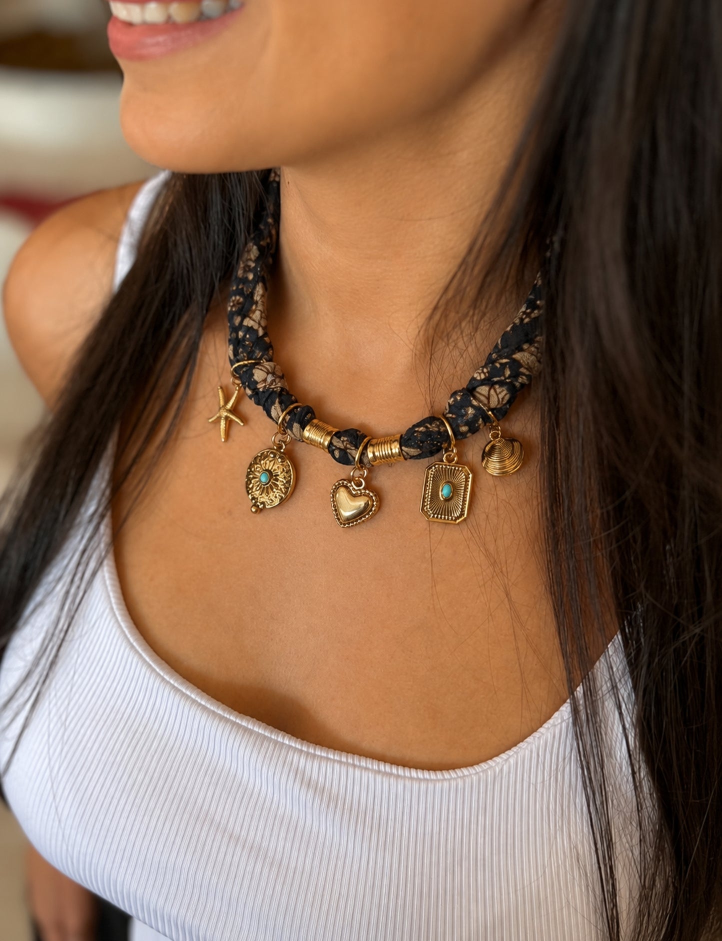 Bandana necklace with gold-plated charms, adjustable tie-back design, stainless steel hardware, handmade statement necklace, sustainable fashion accessory.