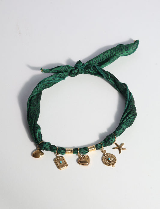 Bandana necklace with gold-plated charms, adjustable tie-back design, stainless steel hardware, handmade statement necklace, sustainable fashion accessory.