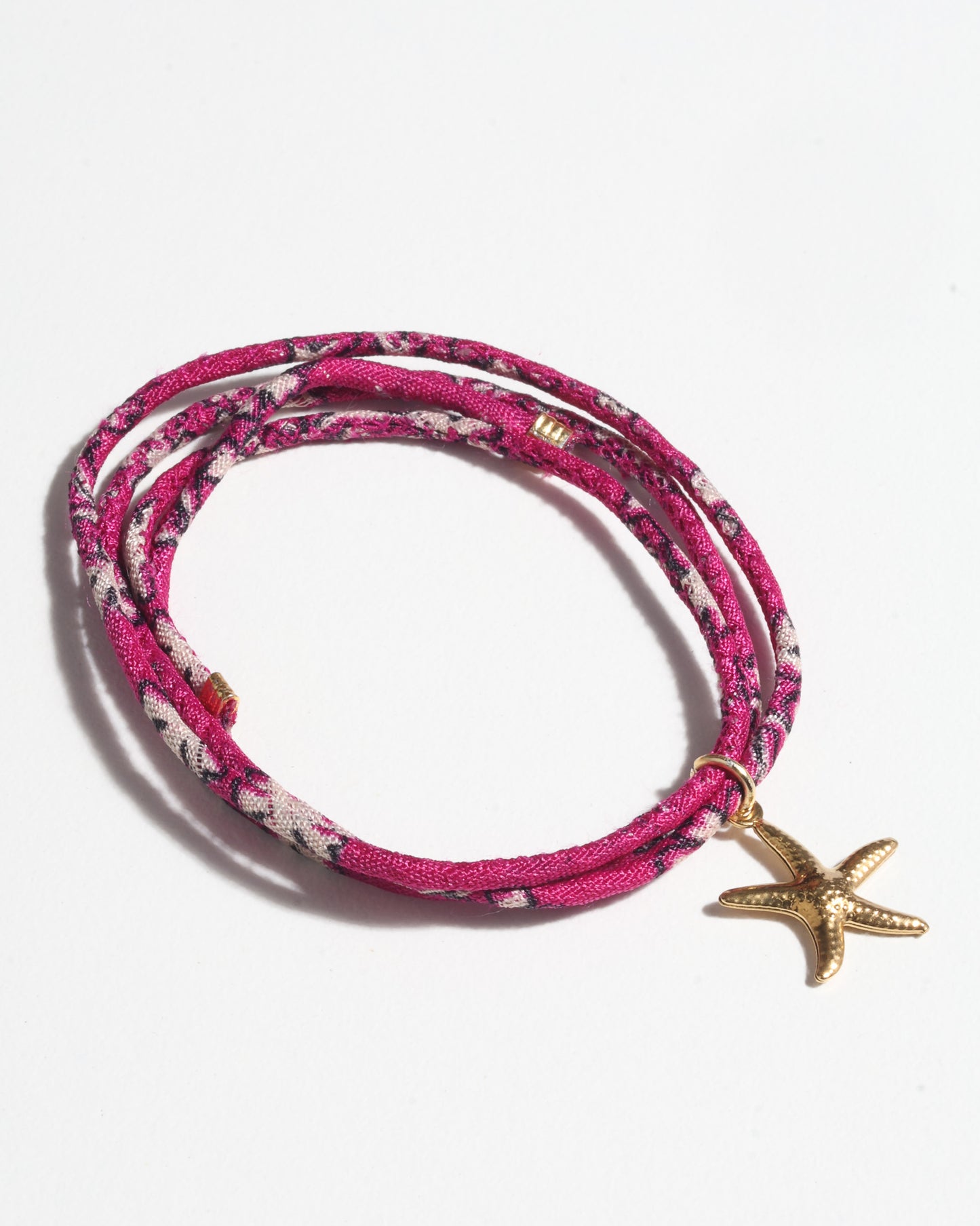 Slim adjustable cord bracelet with gold-plated stainless steel star fish charm inspired by upcycled women’s clothing, sustainable women’s clothing, eco friendly clothes, recycled sustainable fashion, carbon neutral clothing, and environment friendly clothing values.