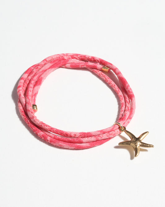 Slim adjustable cord bracelet with gold-plated stainless steel star fish charm inspired by upcycled women’s clothing, sustainable women’s clothing, eco friendly clothes, recycled sustainable fashion, carbon neutral clothing, and environment friendly clothing values.