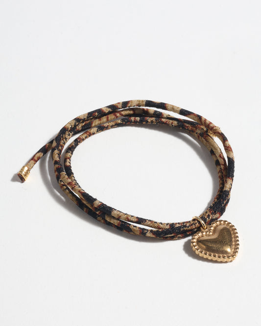 Slim adjustable cord bracelet with gold-plated stainless steel heart charm inspired by upcycled women’s clothing, sustainable women’s clothing, eco friendly fashion, recycled sustainable fashion, carbon neutral fashion, and environment friendly clothes values.
