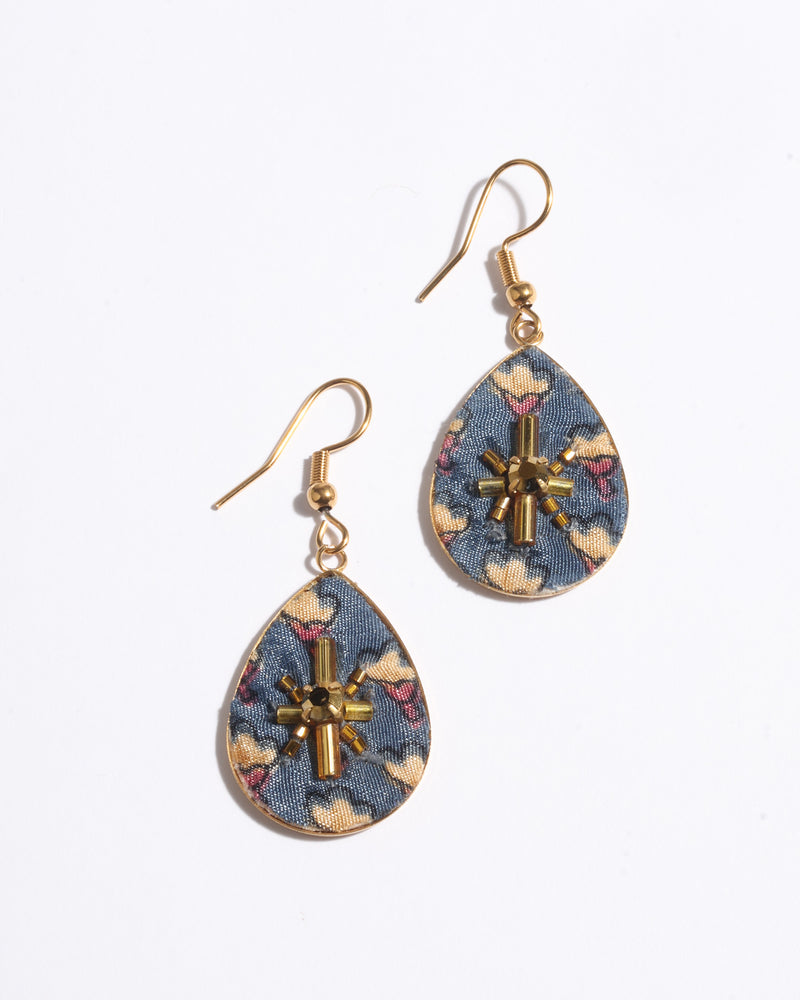 Teardrop earrings with gold hooks, blue fabric base with yellow and pink floral micro design, and gold bead embellishments