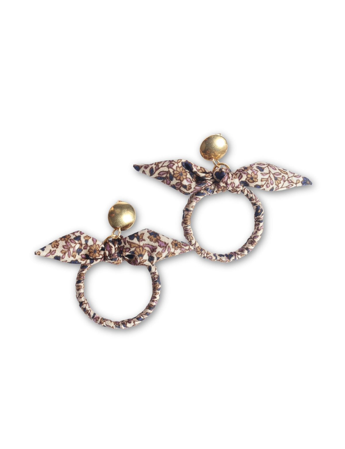 Pair of beige tropical bow earrings with gold round studs and fabric-covered circular hoops with floral print