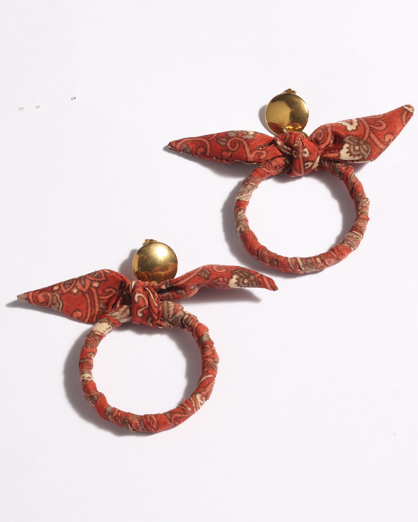 Drop earrings with bow detail and circular ring inspired by upcycled women’s clothing, sustainable women’s clothing, eco friendly clothes, recycled sustainable fashion, carbon neutral clothing, and environment friendly clothing values.