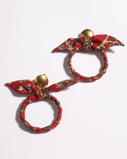 Drop earrings with bow detail and circular ring inspired by upcycled women’s clothing, sustainable women’s clothing, eco friendly clothes, recycled sustainable fashion, carbon neutral clothing, and environment friendly clothing values.
