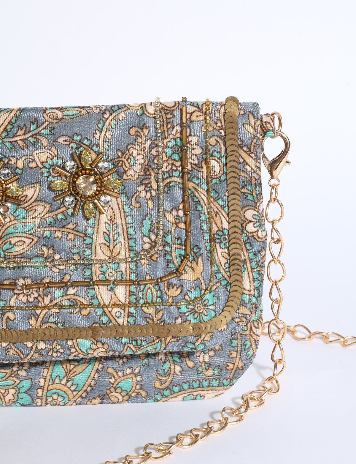 Embroidered evening bag with embellished fold-over flap, tassel detail, and detachable metal chain strap.