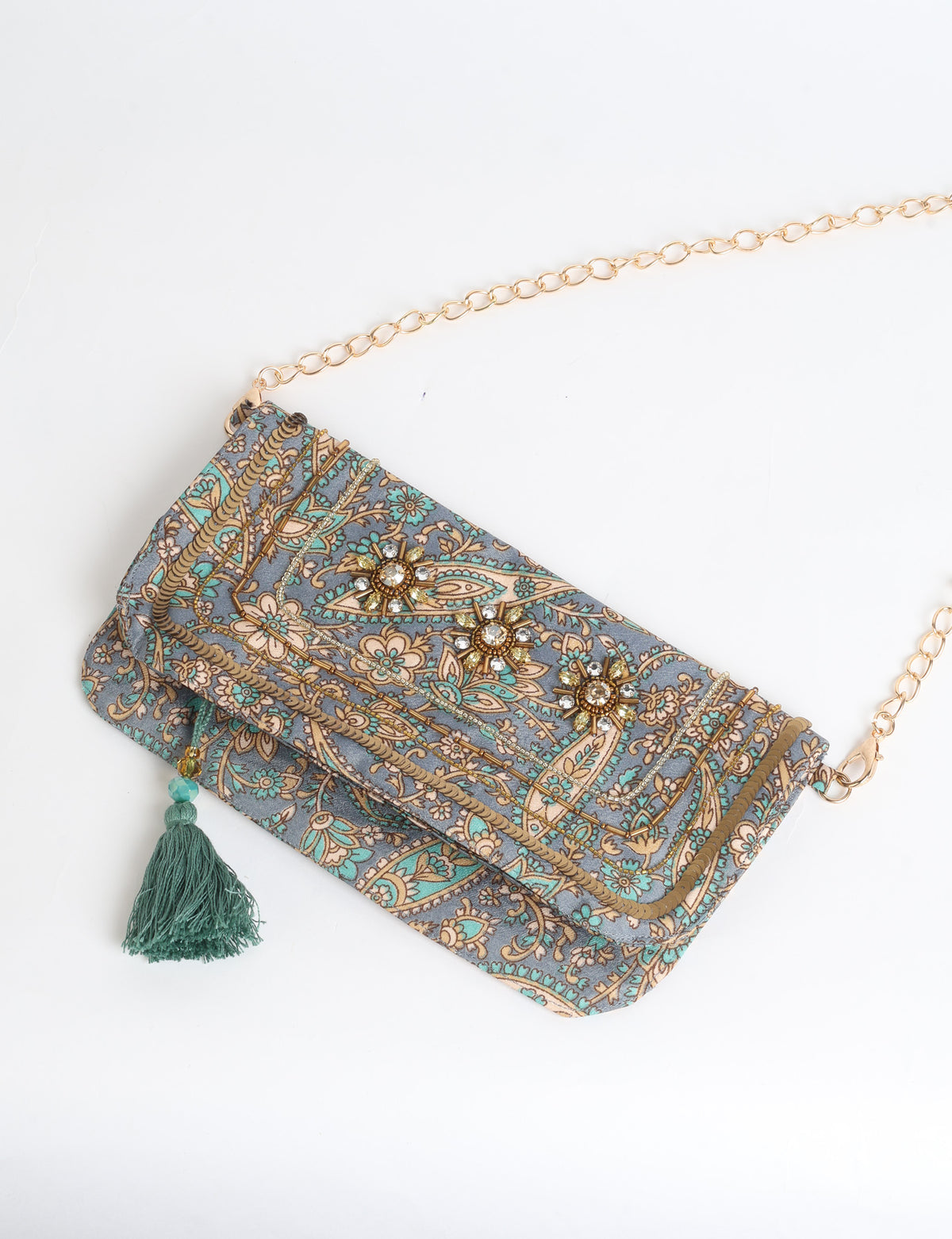 Embroidered evening bag with embellished fold-over flap, tassel detail, and detachable metal chain strap.