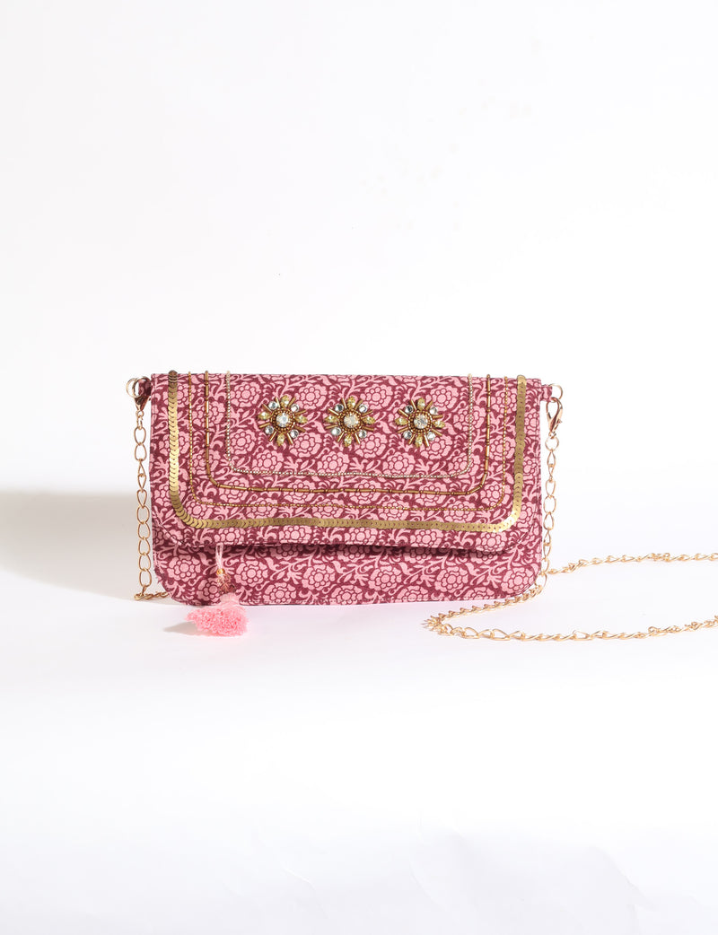 Embroidered evening bag with embellished fold-over flap, tassel detail, and detachable metal chain strap.
