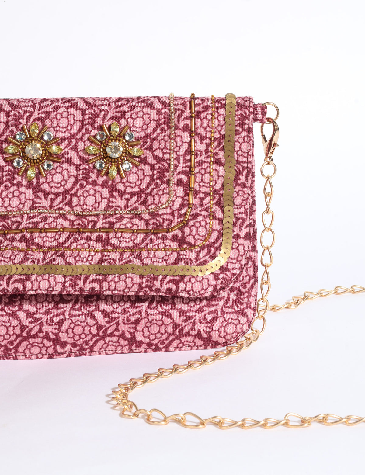 Embroidered evening bag with embellished fold-over flap, tassel detail, and detachable metal chain strap.