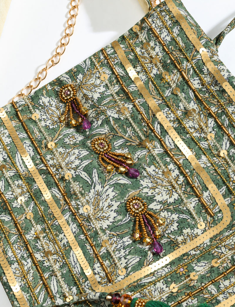 Embroidered DO GOOD potli bag made from upcycled sari fabric with tassel closure and detachable metal chain strap.
