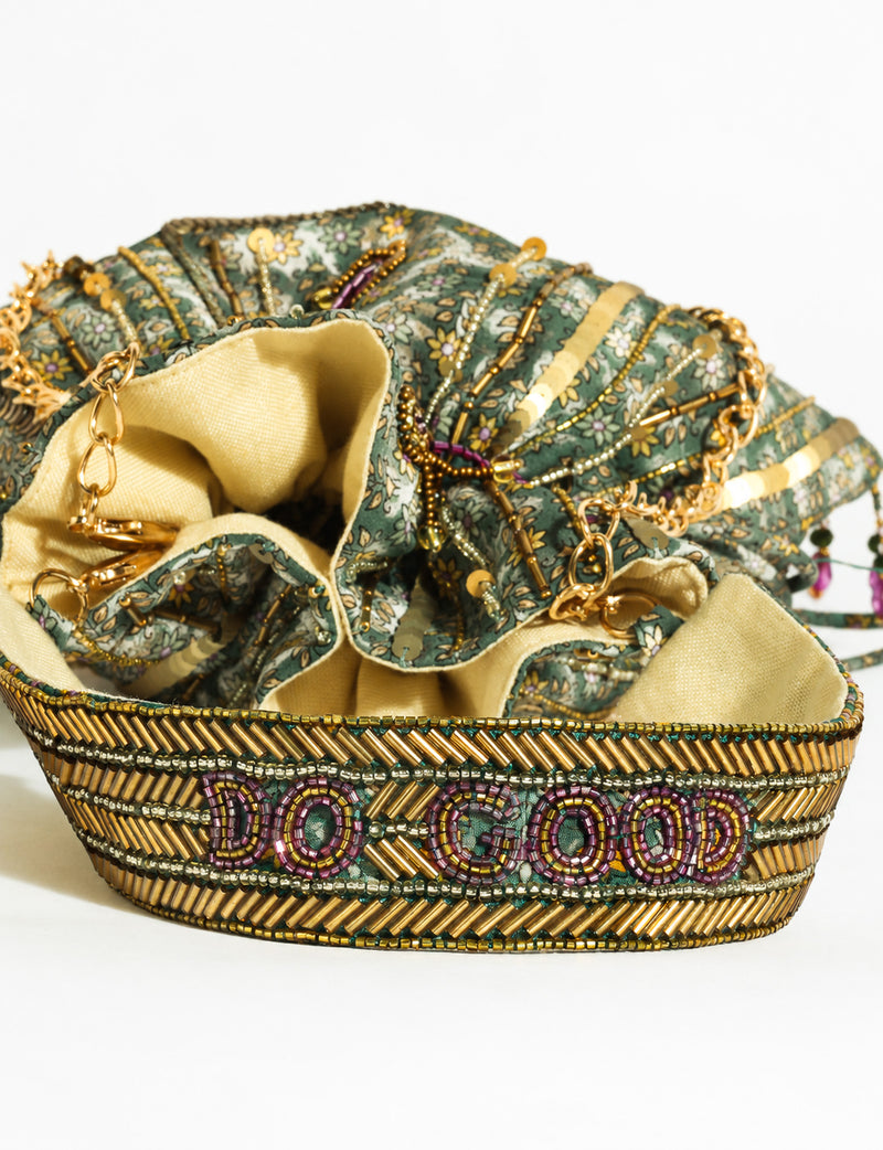 Embroidered DO GOOD potli bag made from upcycled sari fabric with tassel closure and detachable metal chain strap.