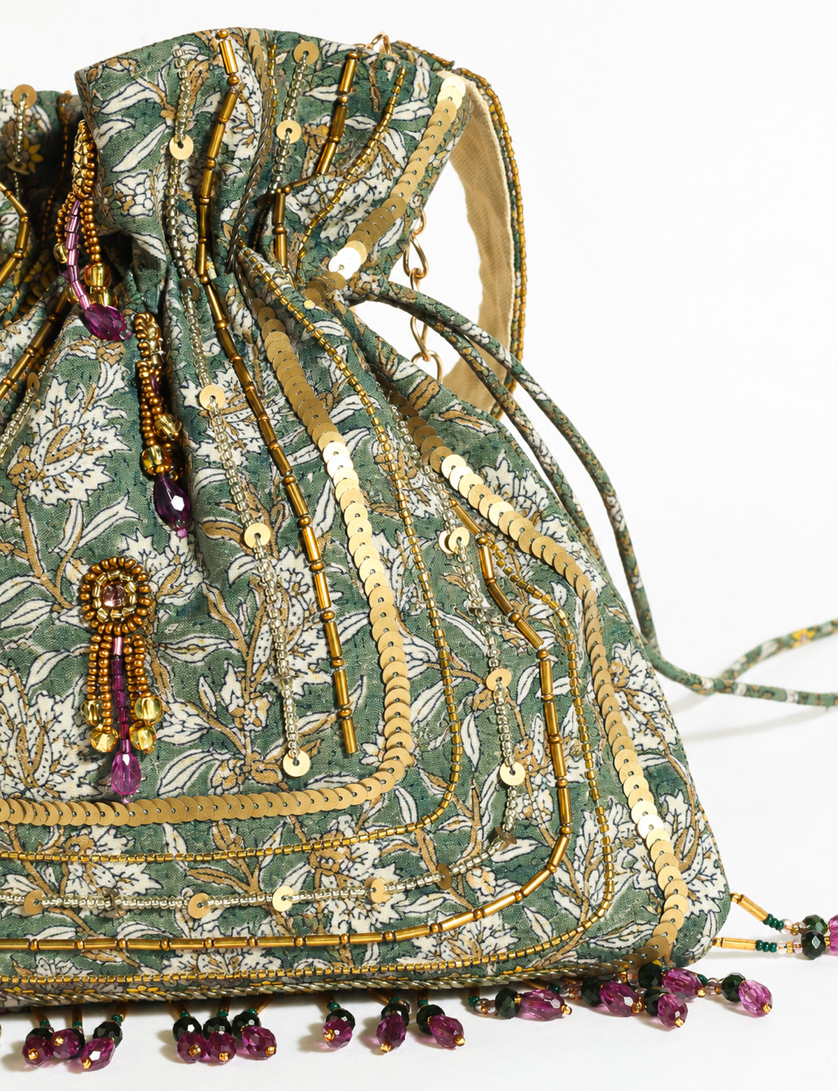 Embroidered DO GOOD potli bag made from upcycled sari fabric with tassel closure and detachable metal chain strap.