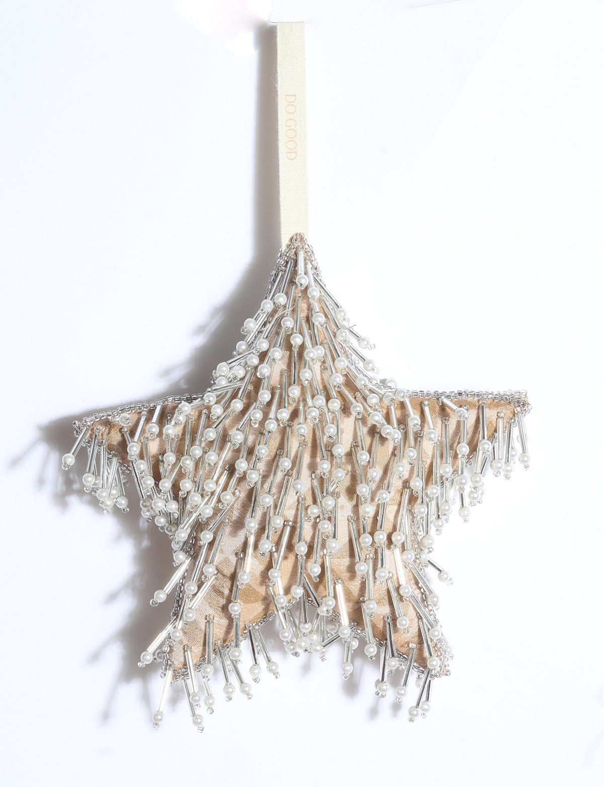 Silver star Christmas ornament made from upcycled ivory and grey saris with silver embroidery, pearls, sequins, and beads.