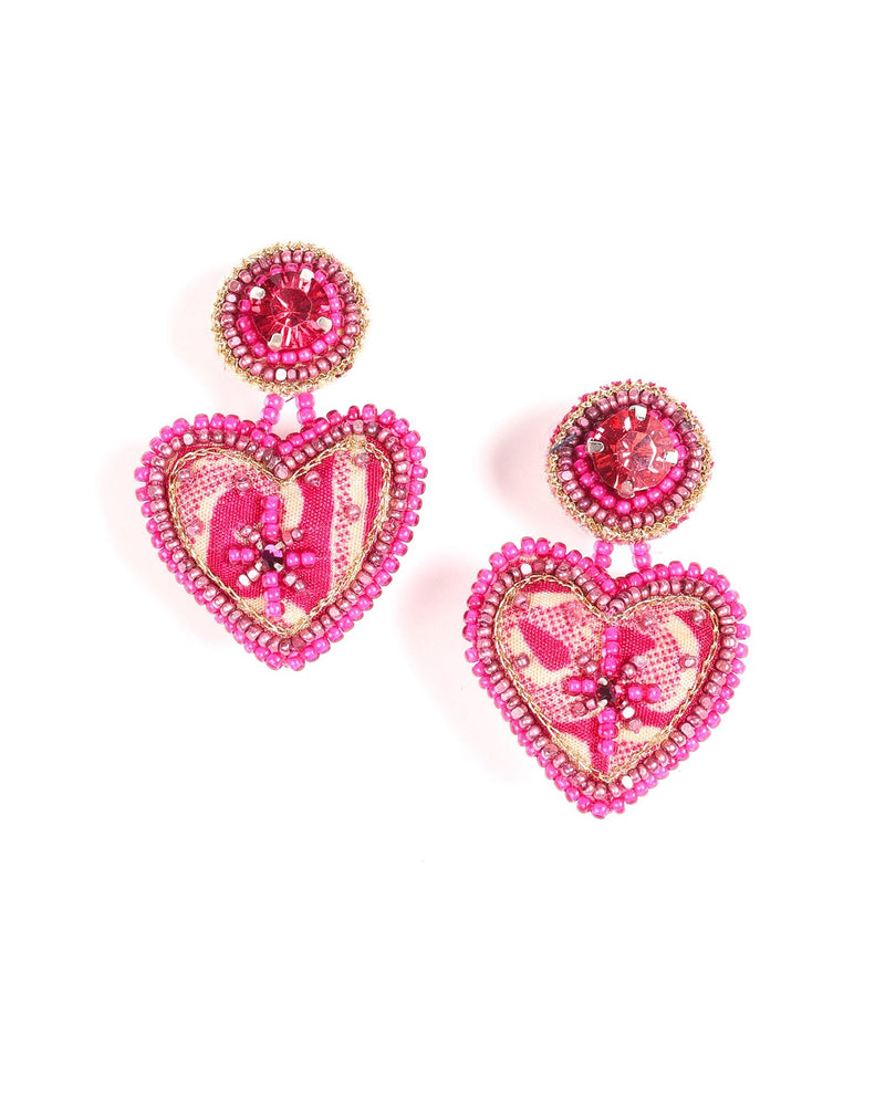 Pink heart drop earrings with beaded edges, fabric heart pattern, and round pink gem studs, shown flat on white background
