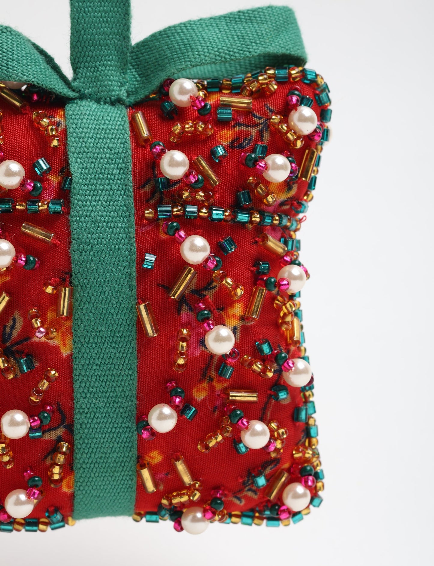 Upcycled bell-shaped Cheer Gift Ornament handmade from recycled sari fabric and decorated with pearls and sequins — an example of eco friendly fashion, recycled clothing, and circular fashion. A festive, earth-friendly decoration from Fair trade fashion and environmentally friendly clothing craftsmanship.