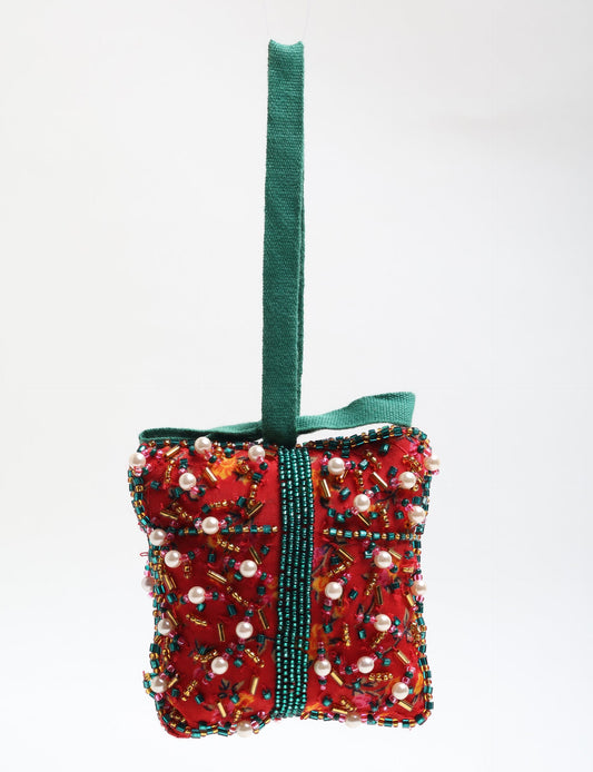 Upcycled bell-shaped Cheer Gift Ornament handmade from recycled sari fabric and decorated with pearls and sequins — an example of eco friendly fashion, recycled clothing, and circular fashion. A festive, earth-friendly decoration from Fair trade fashion and environmentally friendly clothing craftsmanship.