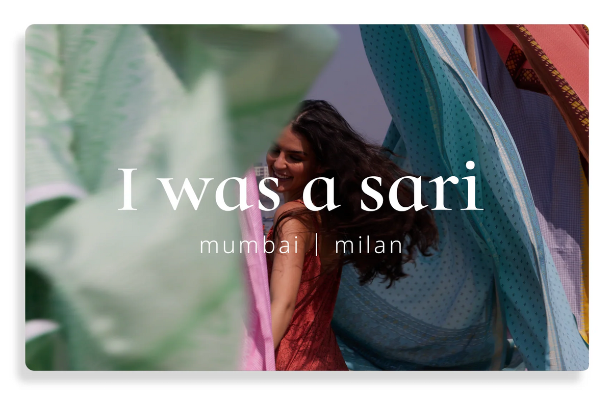 Gift card featuring a smiling woman with long dark hair surrounded by colorful flowing saris in pink, blue, and green