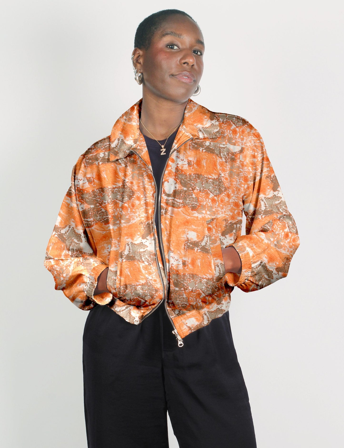 Upcycled Bomber Jacket made from recycled sari materials, featuring a cute cropped shape, elasticated hem and cuffs, and contrast sari print lining. Sustainable apparel promoting eco-friendly fashion and ethical clothing.