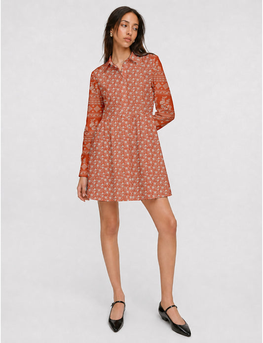 Short shirt dress with a relaxed A-line silhouette, point collar, partial button placket, gathered waist, side pockets, and full-length cuffed sleeves.