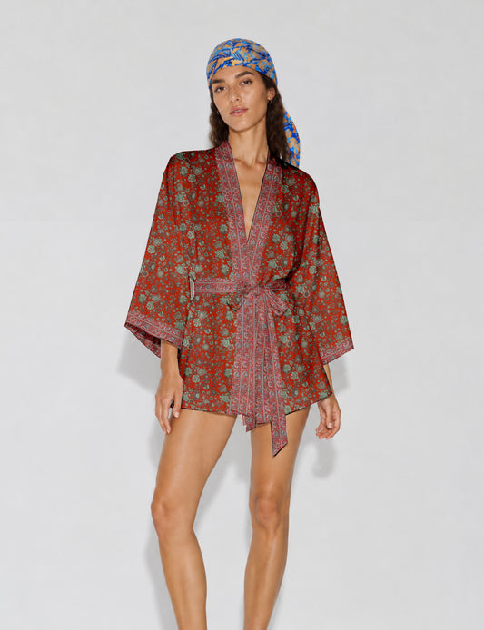 Short kimono robe with wrap front, V-neckline, wide sleeves, waist tie, and concealed skort detail.