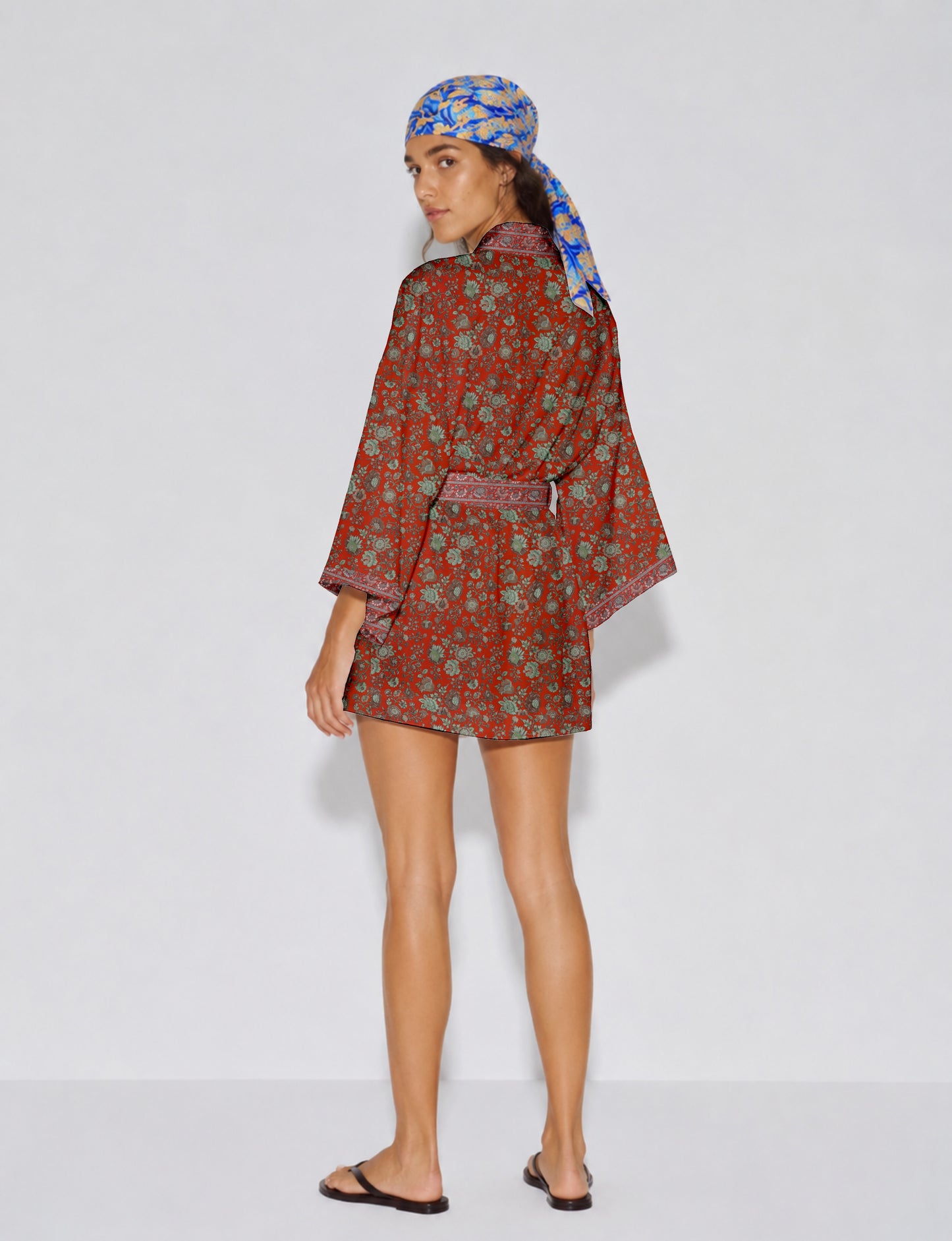 Short kimono robe with wrap front, V-neckline, wide sleeves, waist tie, and concealed skort detail.