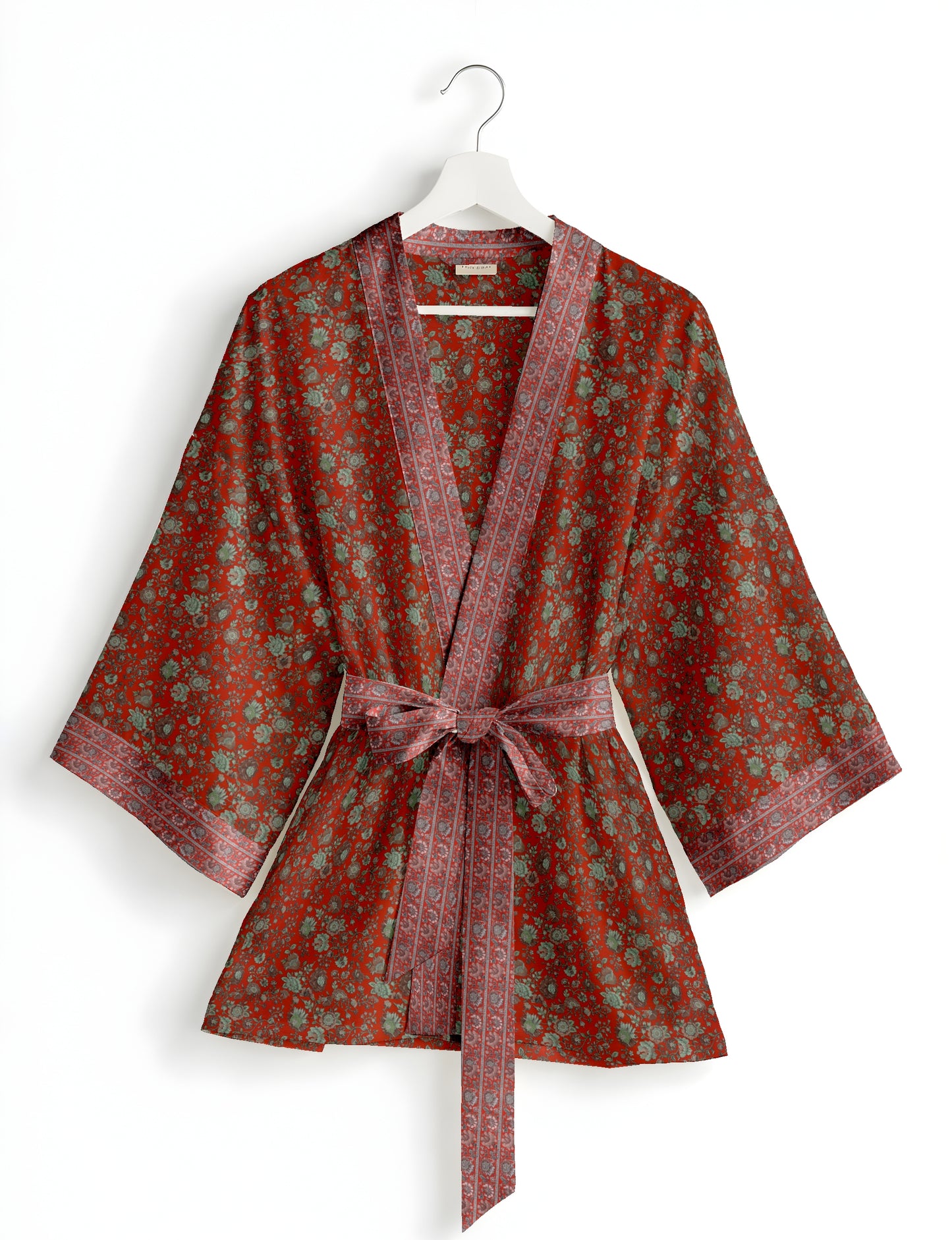 Short kimono robe with wrap front, V-neckline, wide sleeves, waist tie, and concealed skort detail.