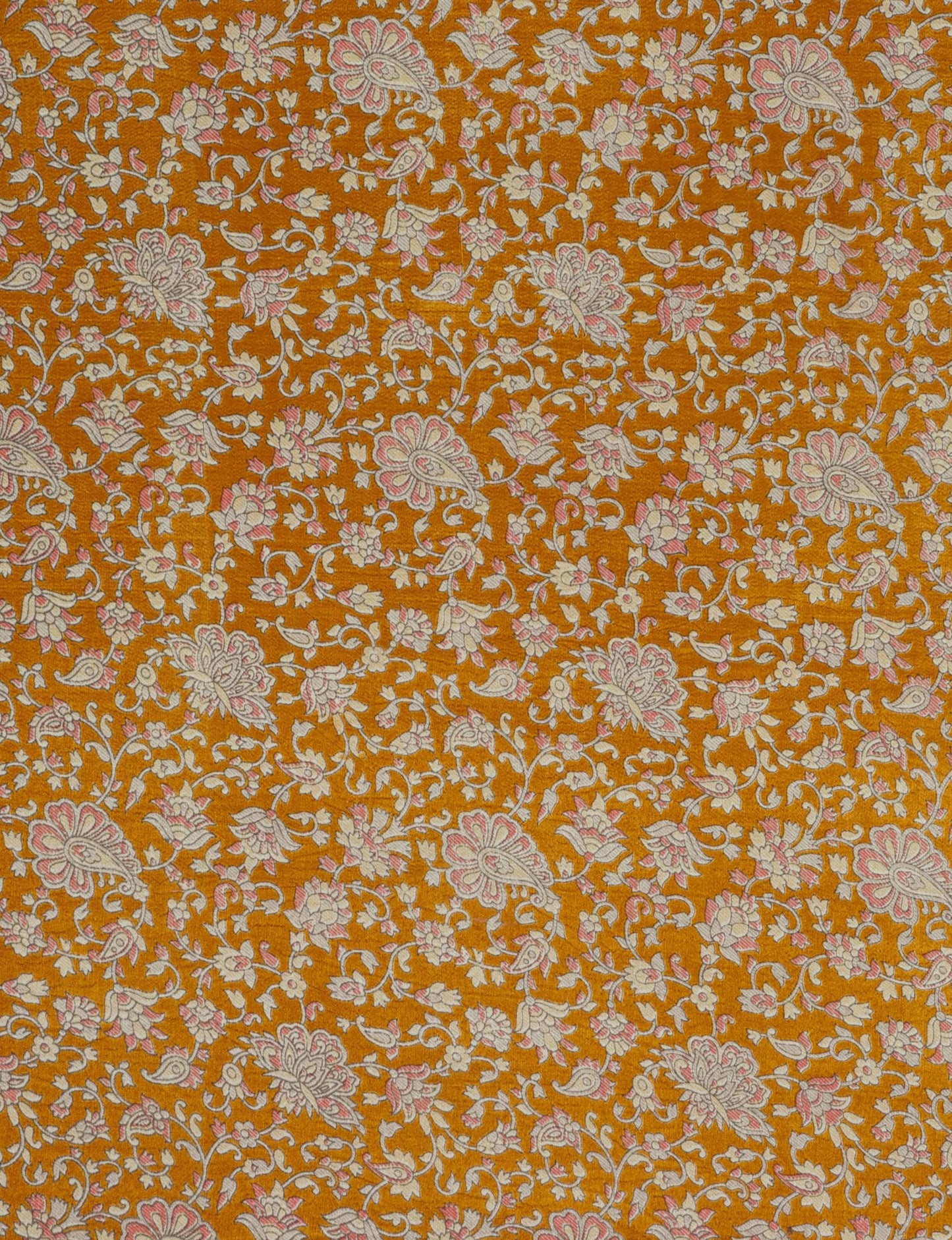 Orange fabric with a floral pattern in cream and pink, featuring paisley and flower motifs on a textured background