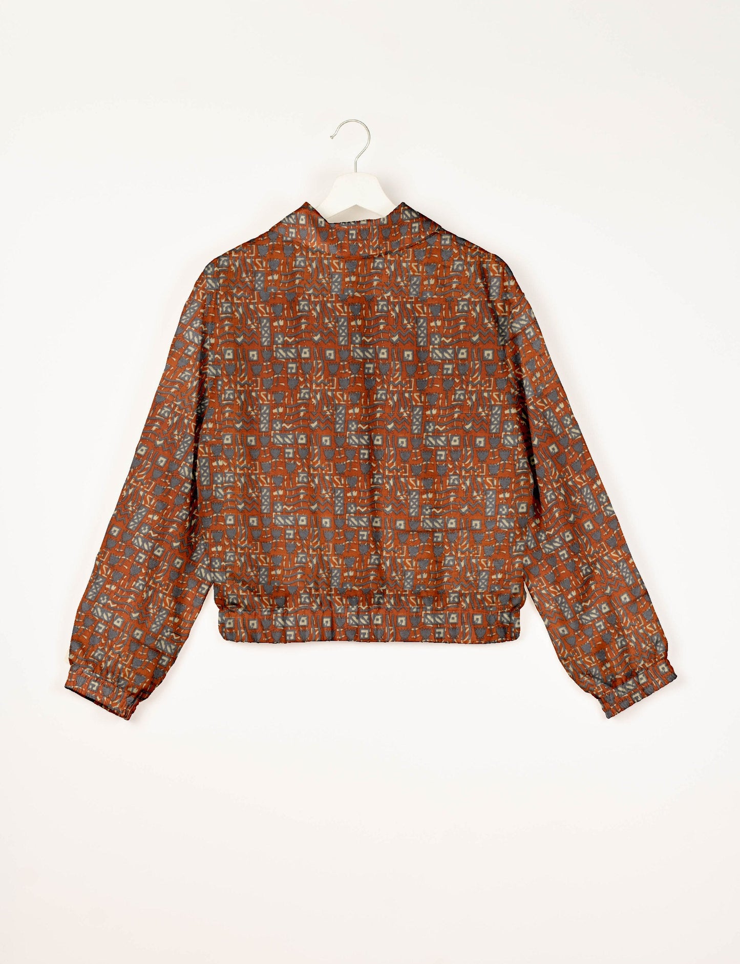 Upcycled Bomber Jacket made from recycled sari materials, featuring a cute cropped shape, elasticated hem and cuffs, and contrast sari print lining. Sustainable apparel promoting eco-friendly fashion and ethical clothing.