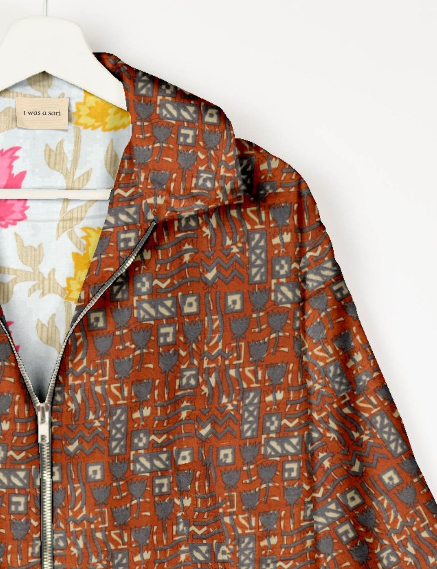 Upcycled Bomber Jacket made from recycled sari materials, featuring a cute cropped shape, elasticated hem and cuffs, and contrast sari print lining. Sustainable apparel promoting eco-friendly fashion and ethical clothing.