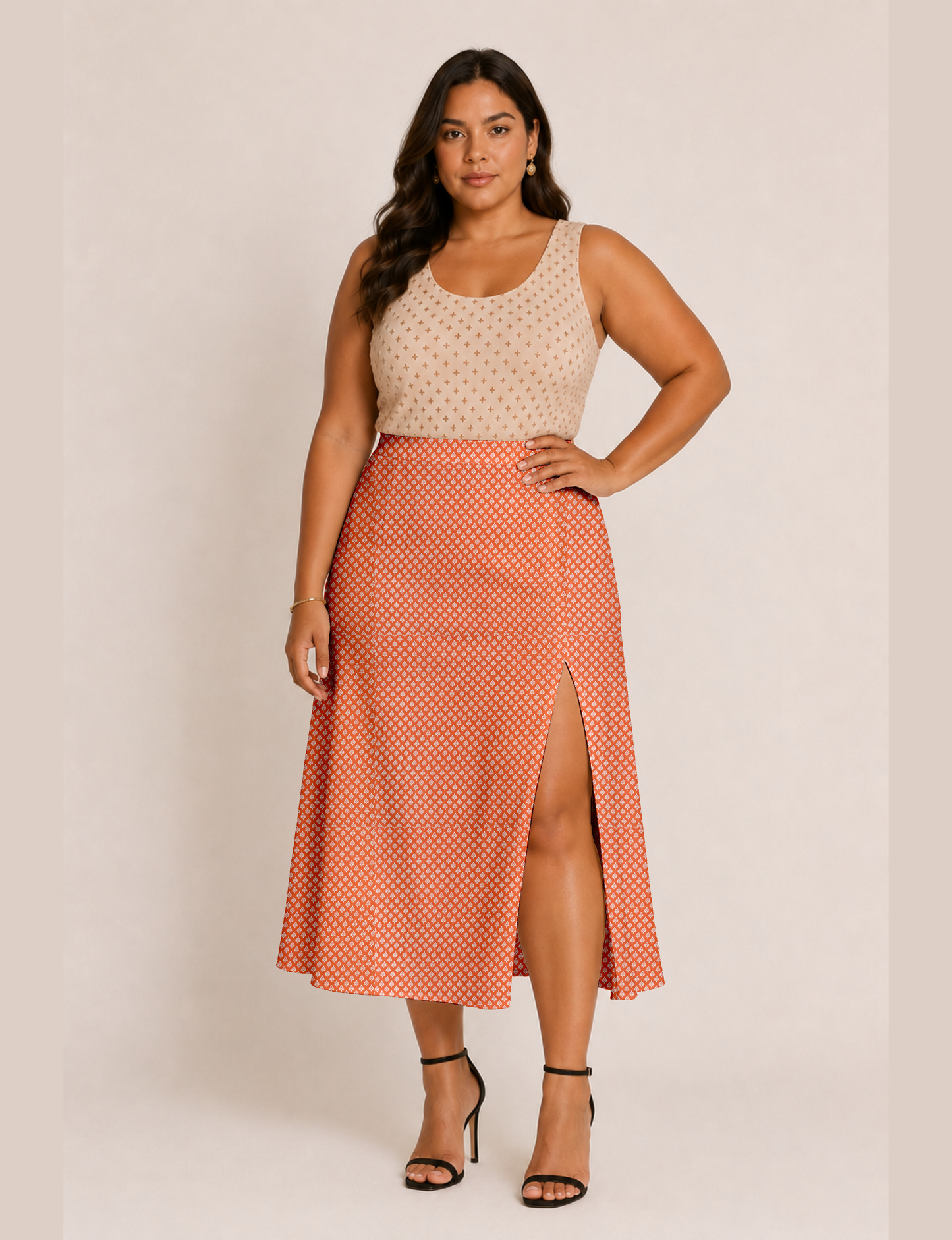 Woman wearing a yellow and black micro patterned A-line skirt with front slit, paired with beige sleeveless top and black