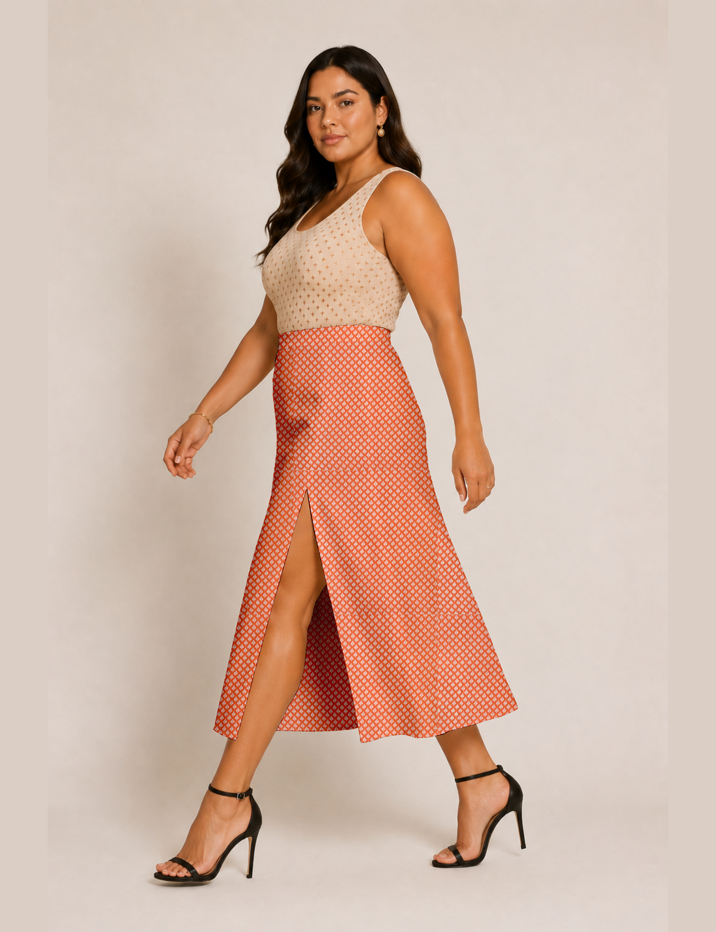 Woman wearing a yellow and black micro patterned A-line skirt with front slit, paired with beige sleeveless top and black