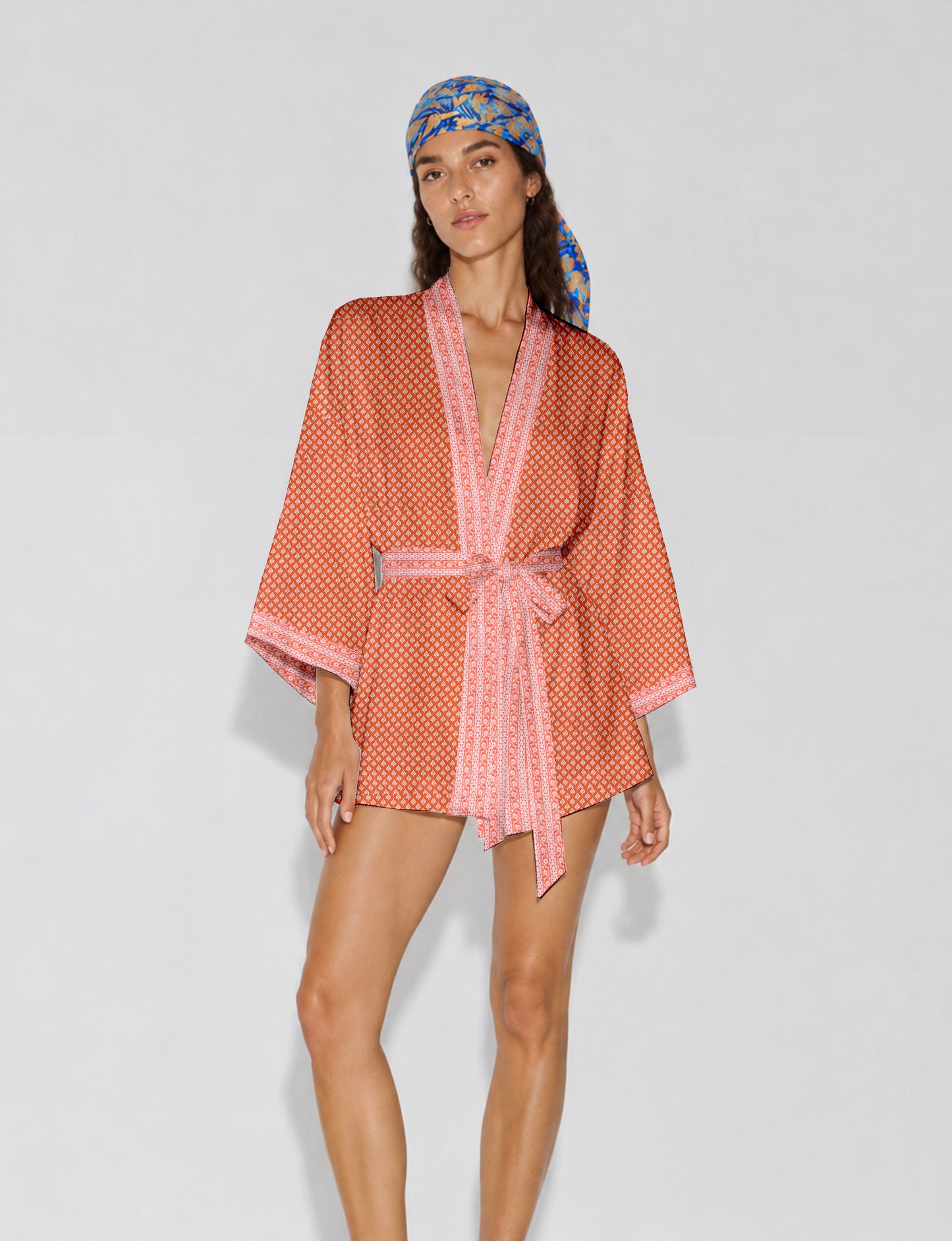 Short kimono robe with wrap front, V-neckline, wide sleeves, waist tie, and concealed skort detail.