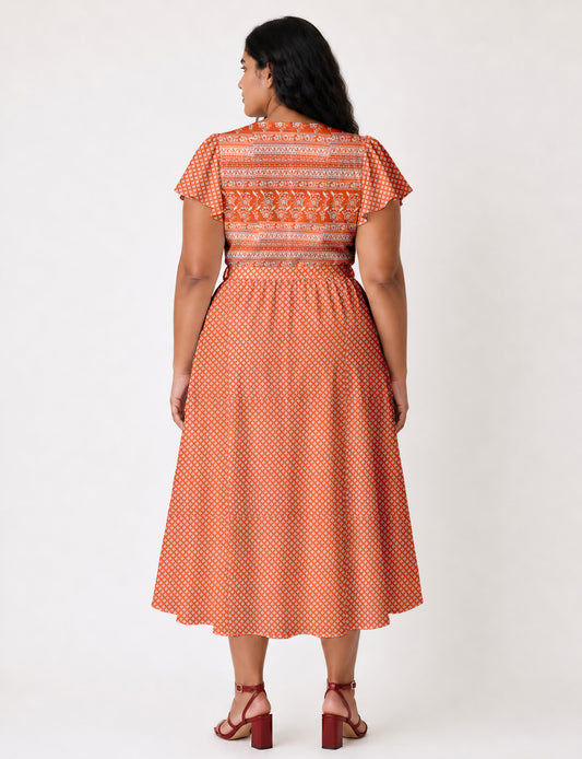Elegant midi wrap dress with a V-neckline, adjustable waist tie, fitted bodice, and flared skirt for a timeless, flattering silhouette.