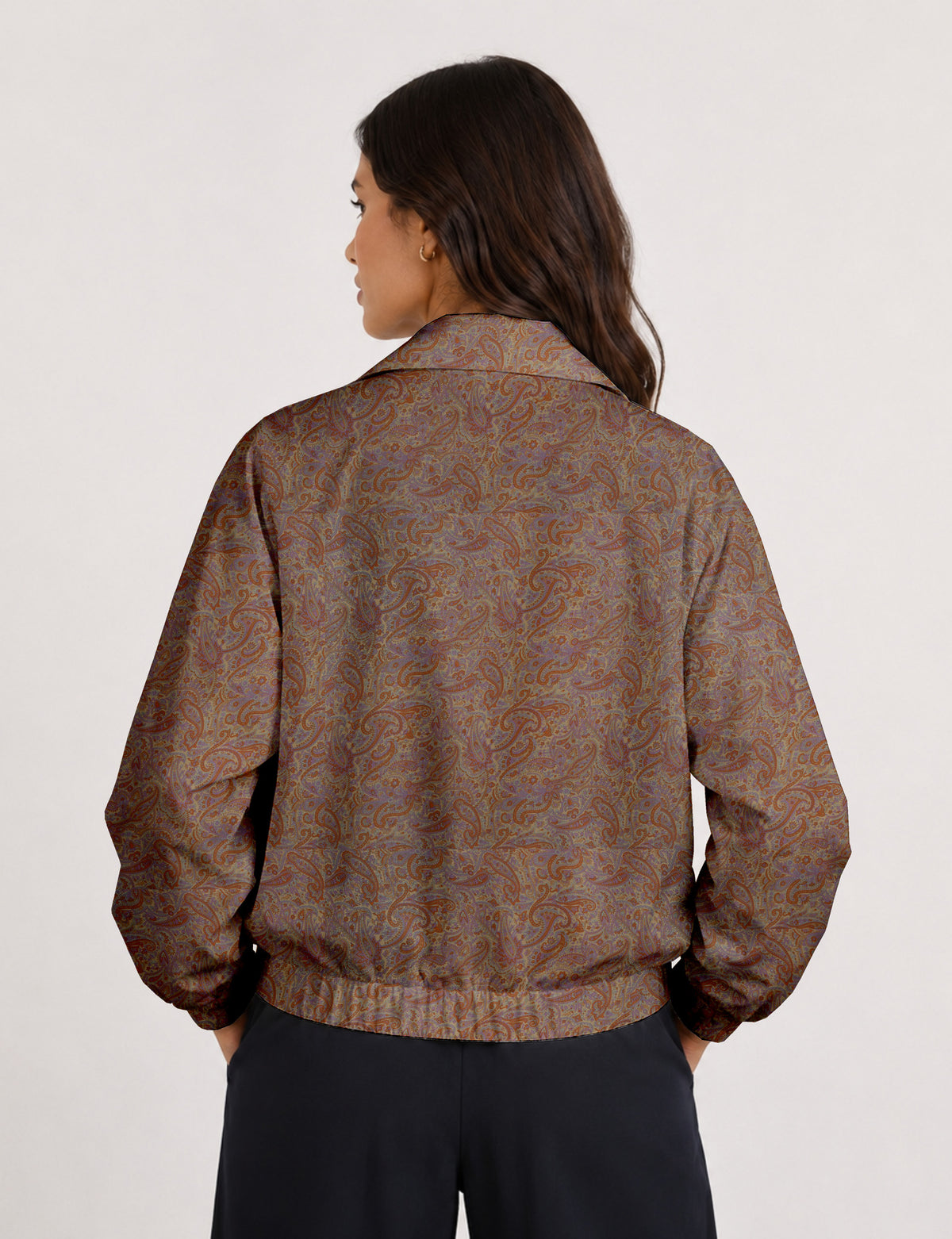Brown floral bomber jacket with front zipper, elastic cuffs and hem, hanging on white hanger, red floral inner lining visible