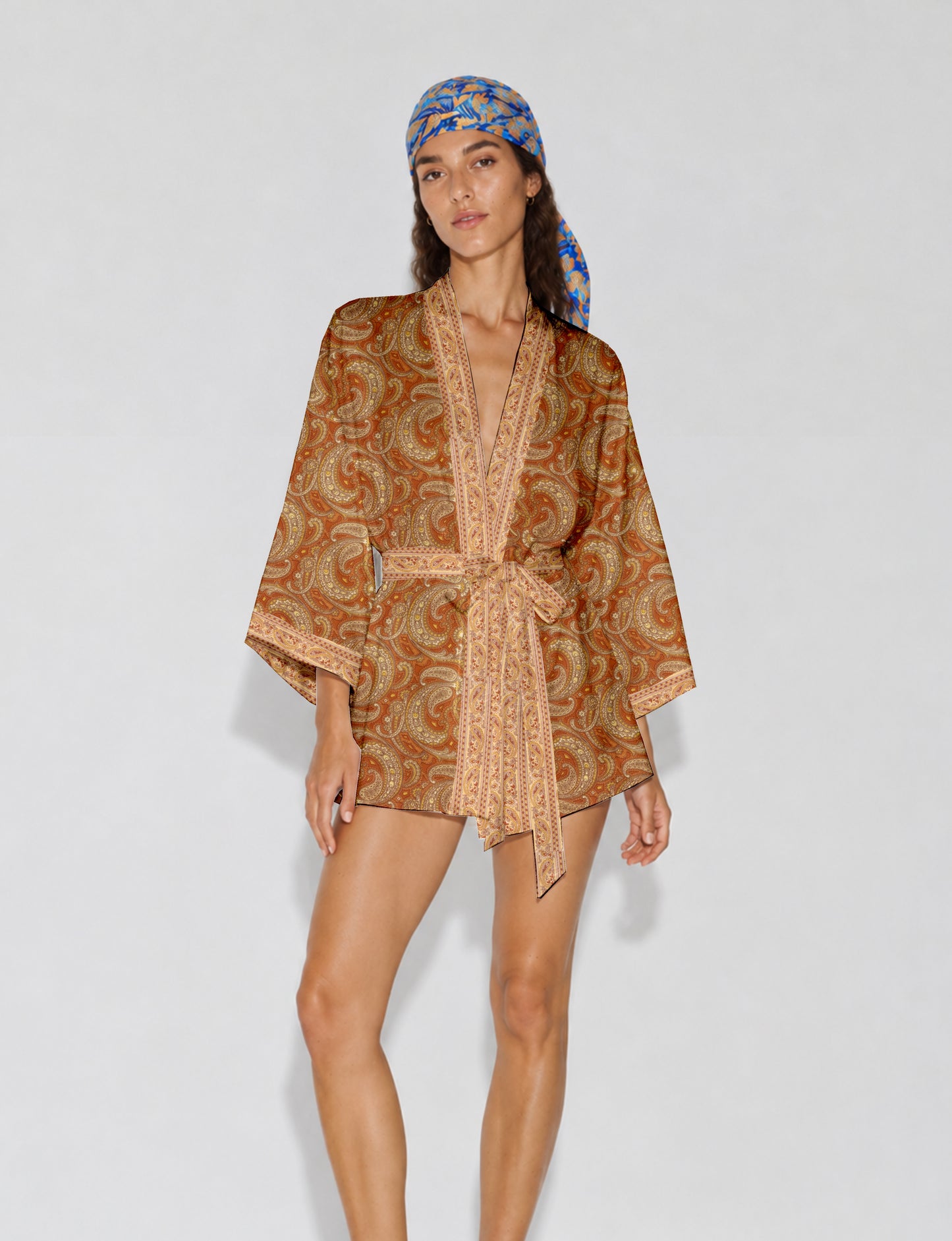 Short kimono robe with wrap front, V-neckline, wide sleeves, waist tie, and concealed skort detail.