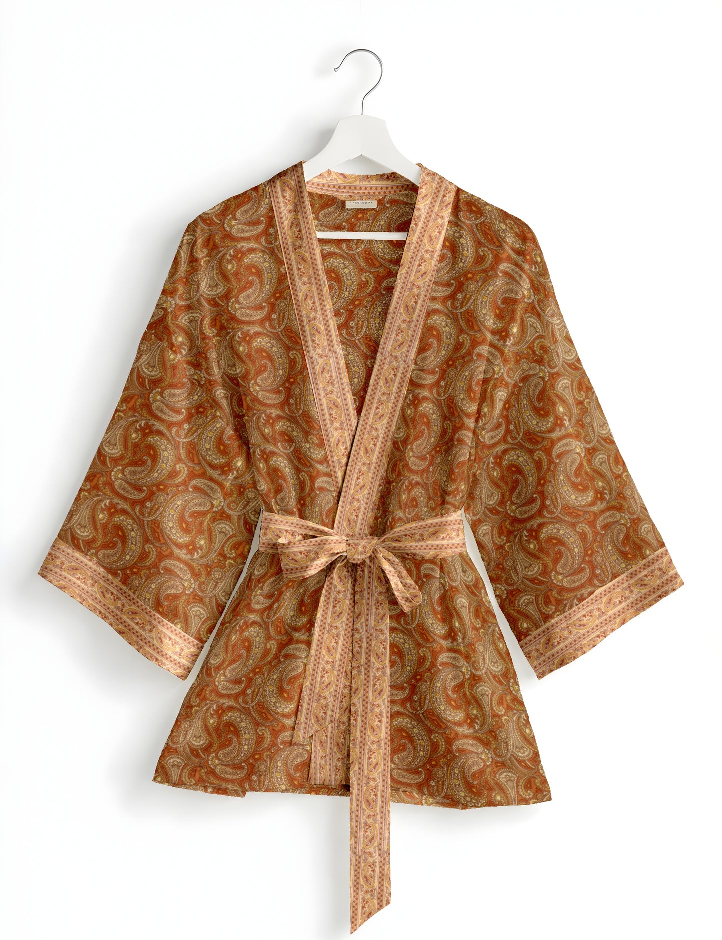 Short kimono robe with wrap front, V-neckline, wide sleeves, waist tie, and concealed skort detail.