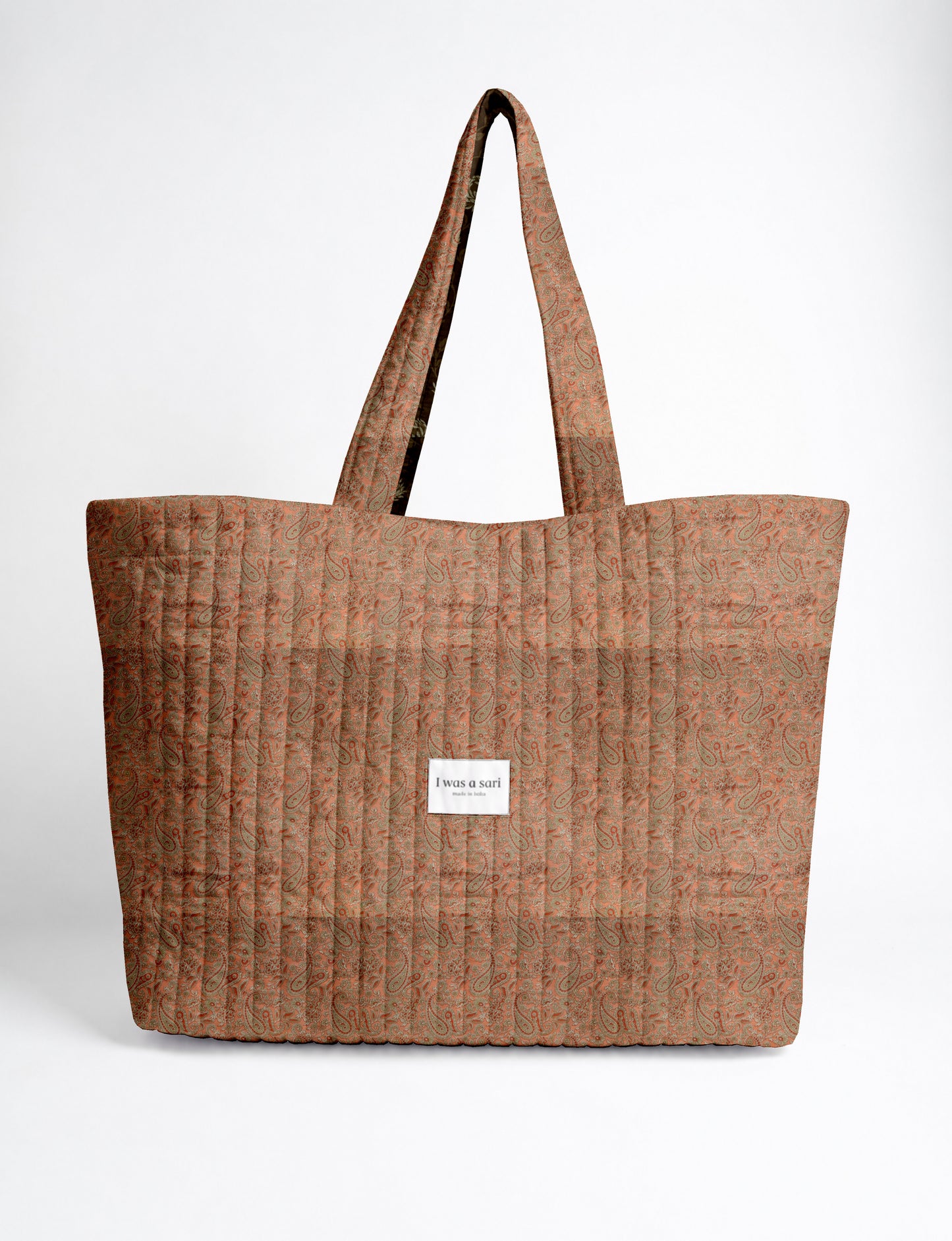 Large quilted beach bag with spacious rectangular design, reinforced shoulder straps, and open-top construction for everyday use and travel.