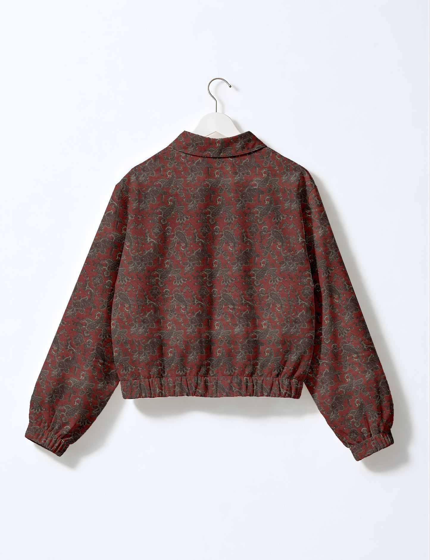 Orange paisley patterned bomber jacket with elastic cuffs and waistband, shown from back on white hanger