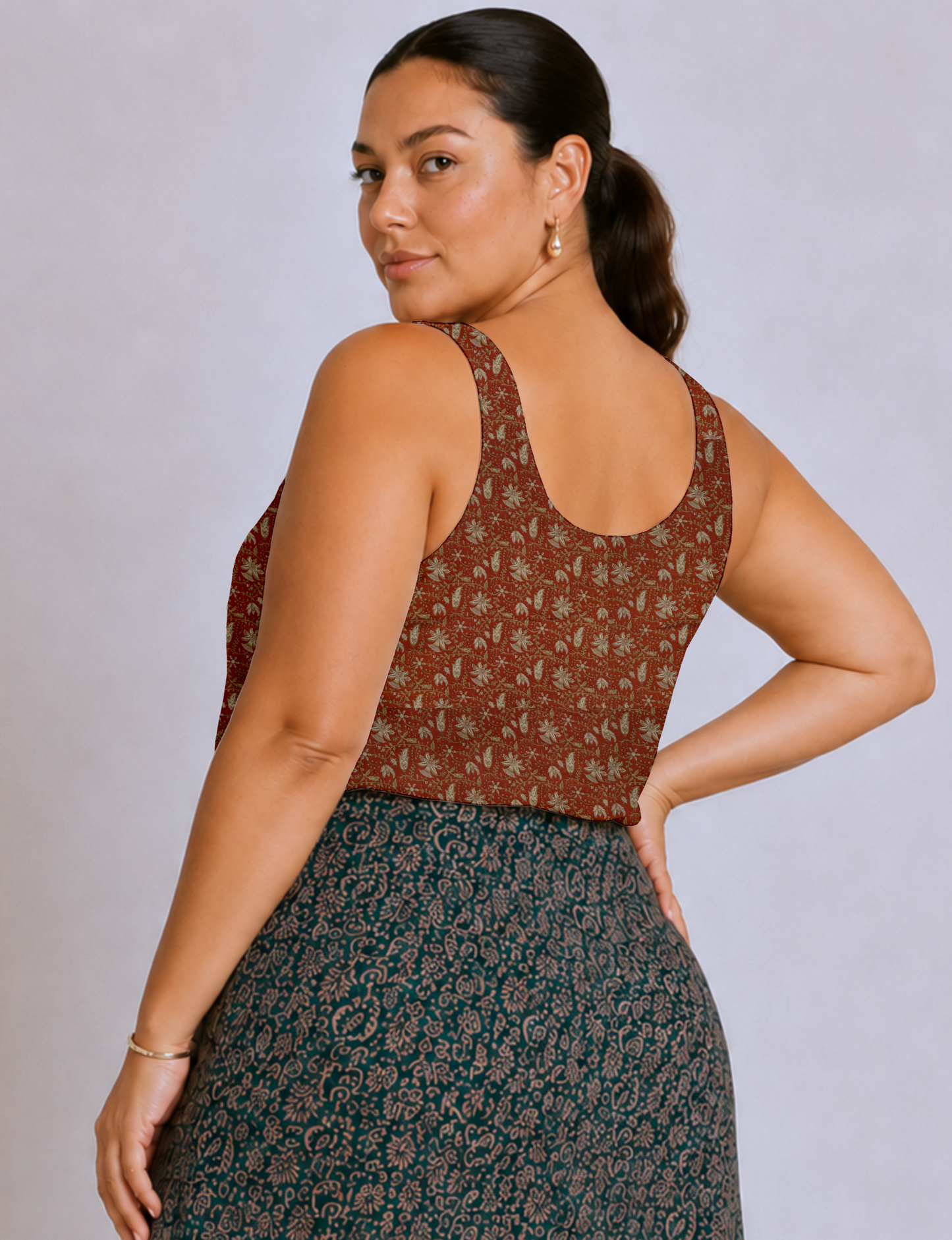 Women's sleeveless blouse with a relaxed straight fit, wide scoop neckline, deep scoop back, and hip-length silhouette.